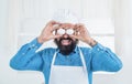handsome man with beard and moustache cooking food. professional restaurant cook baking. skilled baker cooking eggs in Royalty Free Stock Photo