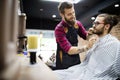 Client during beard and moustache grooming in barber shop