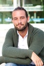 Handsome man with beard sitting and smiling Royalty Free Stock Photo