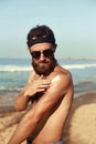 Handsome Man with beard, Sunbathing With Sunscreen Lotion Body In Summer. Male Fitness Model Tanning Using Solar Block Cream For H Royalty Free Stock Photo