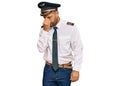 Handsome man with beard wearing airplane pilot uniform tired rubbing nose and eyes feeling fatigue and headache Royalty Free Stock Photo