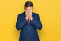 Handsome man with beard wearing business suit and tie with sad expression covering face with hands while crying Royalty Free Stock Photo