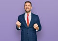 Handsome man with beard wearing business suit and tie very happy and excited doing winner gesture with arms raised, smiling and Royalty Free Stock Photo