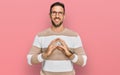 Handsome man with beard wearing casual clothes and glasses hands together and fingers crossed smiling relaxed and cheerful Royalty Free Stock Photo