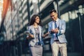 Man and beautiful woman as business partners using digital tablet outdoor Royalty Free Stock Photo