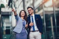 Young man and beautiful woman as business partners using digital tablet outdoor Royalty Free Stock Photo