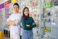 handsome man and beautiful woman smiling with crossed hands near cell phone accessories display case Royalty Free Stock Photo