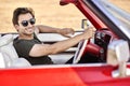 Handsome man behind the wheel of a red car Royalty Free Stock Photo