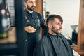 Kind bearded male person sitting in semi position Royalty Free Stock Photo