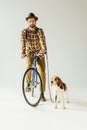 handsome man on bike with beagle looking at camera