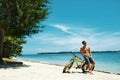 Handsome Man With Bike Sun Tanning On Beach. Summer Vacation. Royalty Free Stock Photo