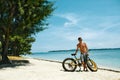 Handsome Man With Bike Sun Tanning On Beach. Summer Vacation. Royalty Free Stock Photo