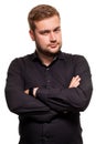 Handsome man in a black shirt, isolated on a white background, feeling great and comfortable. Royalty Free Stock Photo