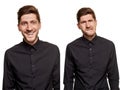 Handsome man in a black shirt makes faces, standing against a white background Royalty Free Stock Photo