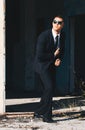 Handsome man in black suit and sunglasses. Secret agent, mafia, bodyguard concept Royalty Free Stock Photo