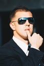 Handsome man in black suit and sunglasses. Secret agent, mafia, bodyguard concept Royalty Free Stock Photo