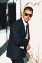 Handsome man in black suit and sunglasses. Secret agent, mafia, bodyguard concept Royalty Free Stock Photo