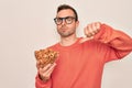 Handsome man with blue eyes holding bowl with healthy almonds snack over white background with angry face, negative sign showing Royalty Free Stock Photo