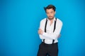 Handsome man on blue wearing white shirt and braces Royalty Free Stock Photo