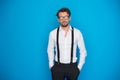 Handsome man on blue wearing white shirt and braces Royalty Free Stock Photo