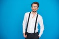 Handsome man on blue wearing white shirt and braces Royalty Free Stock Photo