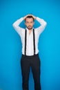 Handsome man on blue wearing white shirt and braces Royalty Free Stock Photo