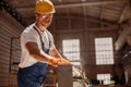 Handsome man builder using woodworking machine in workshop Royalty Free Stock Photo