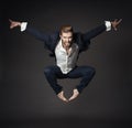 Handsome Man in Business Suit Jumping in Air, Full Length Young Ballet Dancer over Black Background Royalty Free Stock Photo