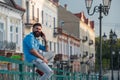 Handsome man call phone and smile outdoor city street. Attractive businessman in casual blue shirt talking on mobile. Royalty Free Stock Photo