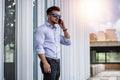 Handsome man calling on cellphone outside on urban background. Royalty Free Stock Photo