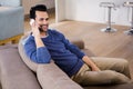 Handsome man calling on the couch Royalty Free Stock Photo