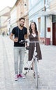 Handsome man with a camera and beautiful girl with her bike Royalty Free Stock Photo