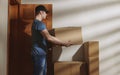 Handsome man delivers cardboard boxes