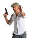 Handsome man in cap with a gun Royalty Free Stock Photo