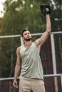 Handsome man catching baseball ball on court