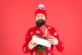 Handsome man celebrate winter holidays red background. Christmas shopping. Secret Santa could ease holiday stress. Merry Royalty Free Stock Photo