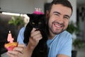 Handsome man celebrating his catÂ´s birthday Royalty Free Stock Photo