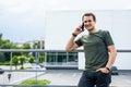 Handsome man cell phone call smile outdoor city street. Young attractive businessman casual blue shirt talking on the phone Royalty Free Stock Photo