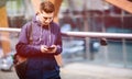 Handsome man cell phone outdoor city street, Young attractive student casual blue shirt talking Royalty Free Stock Photo