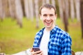 Handsome man cell phone call smile outdoor city street, Young attractive guy blue shirt use smartphone Royalty Free Stock Photo