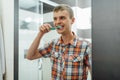 Handsome man cleans teeth in the bathroom and smiling Royalty Free Stock Photo