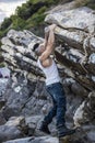 Handsome Man Climbing a Rock at the River Royalty Free Stock Photo