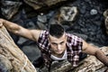 Handsome Man Climbing a Rock at the River Royalty Free Stock Photo