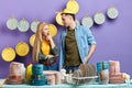 Handsome man with colander on his head and beautiul blonde woman talking