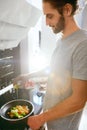 Handsome Man Cooking Breakfast At Home In Kitchen. Royalty Free Stock Photo