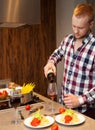 Handsome man cooking at home preparing pasta Royalty Free Stock Photo