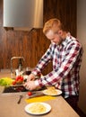 Handsome man cooking at home preparing pasta Royalty Free Stock Photo