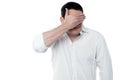 Handsome man covering his eyes with hand Royalty Free Stock Photo