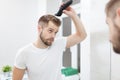 Handsome man cutting his own hair with a clipper Royalty Free Stock Photo