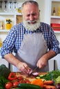 Handsome man cutting onion on chopping board Royalty Free Stock Photo